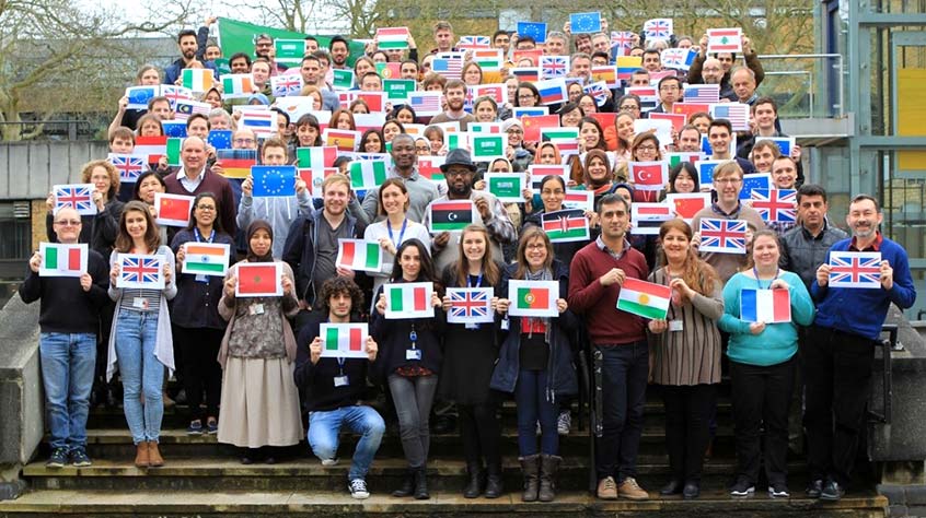 all staff from the Department of Genetics and Genome Biology holding flags